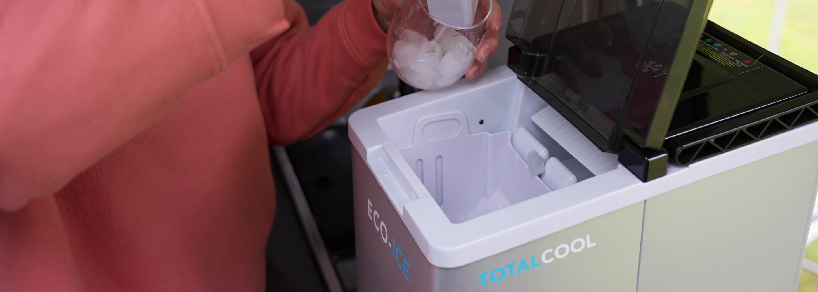 Image of a person collecting ice from the Eco ice portable ice maker