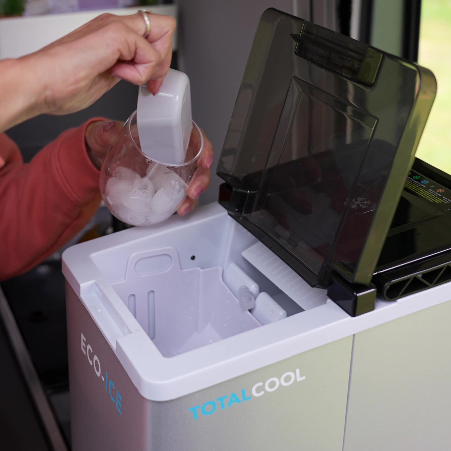 Image of a person collecting ice from the Eco ice portable ice maker