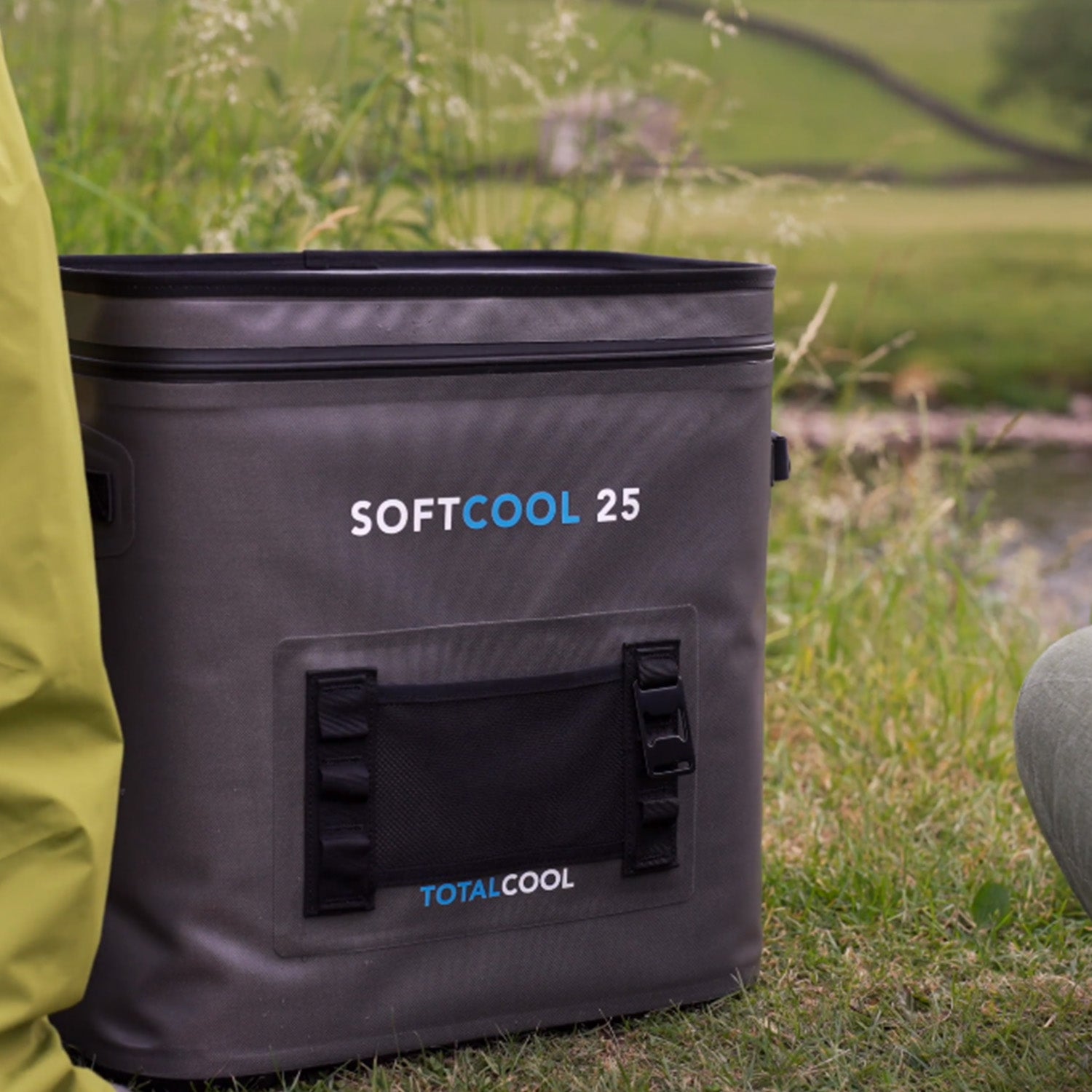 Image of the grey softcool 25 coolbag outside on the grass