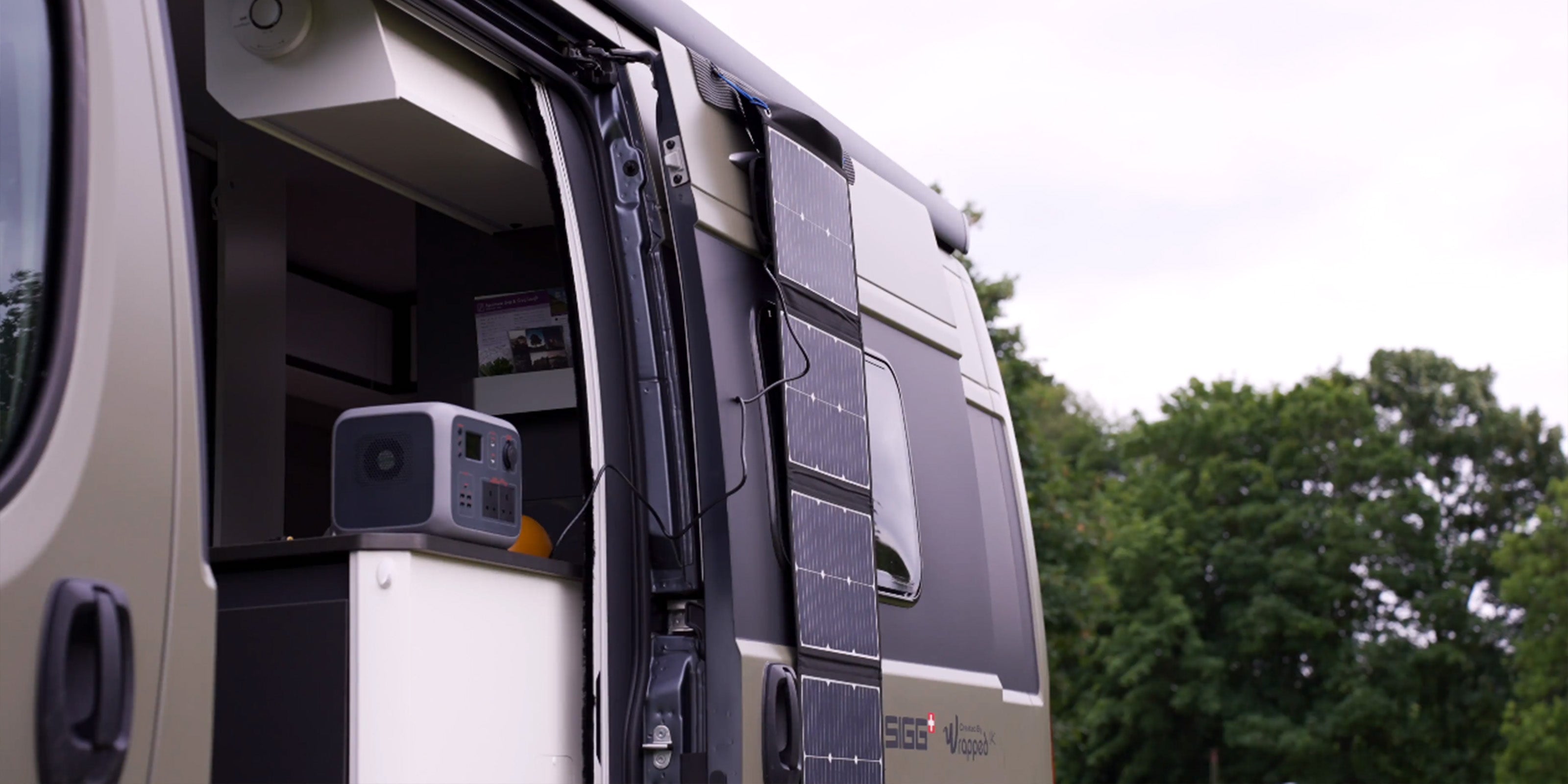 Image of TS100 Solar panel on the side of a campervan charging a TP500 battery