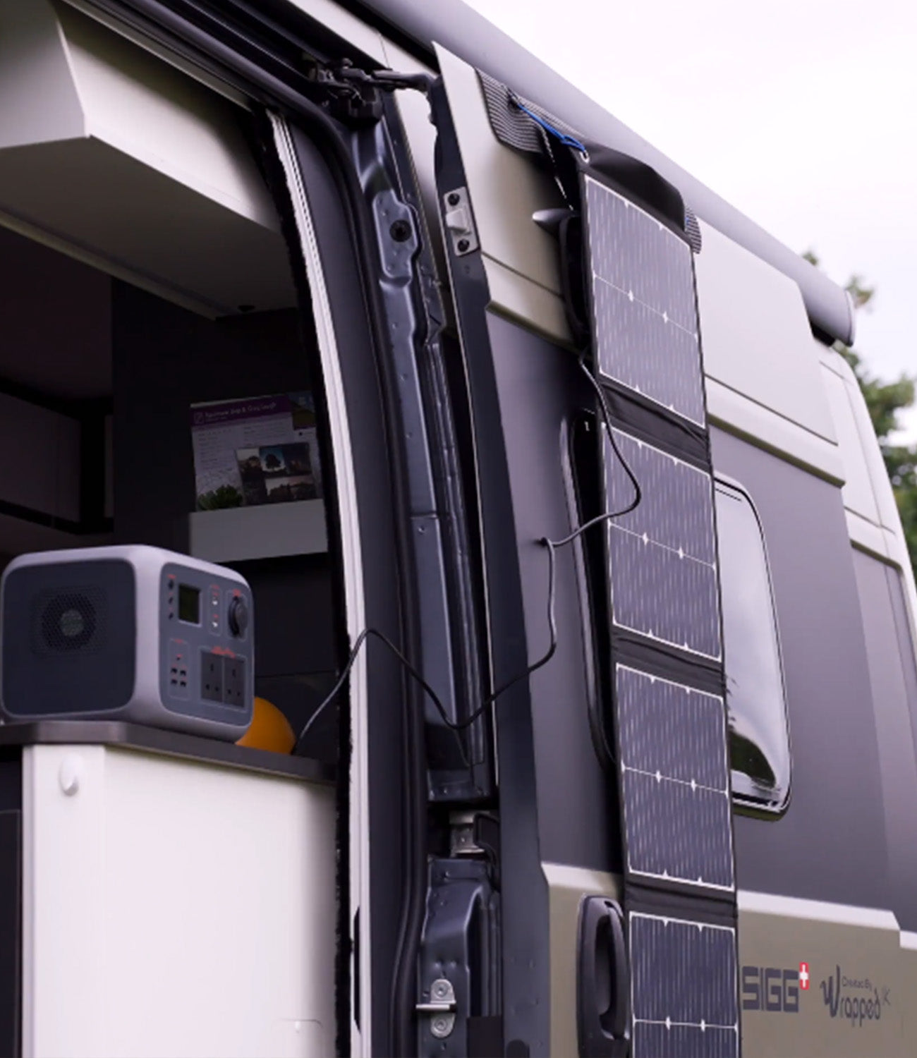 Image of TS100 Solar panel on the side of a caravan charging a TP500 battery