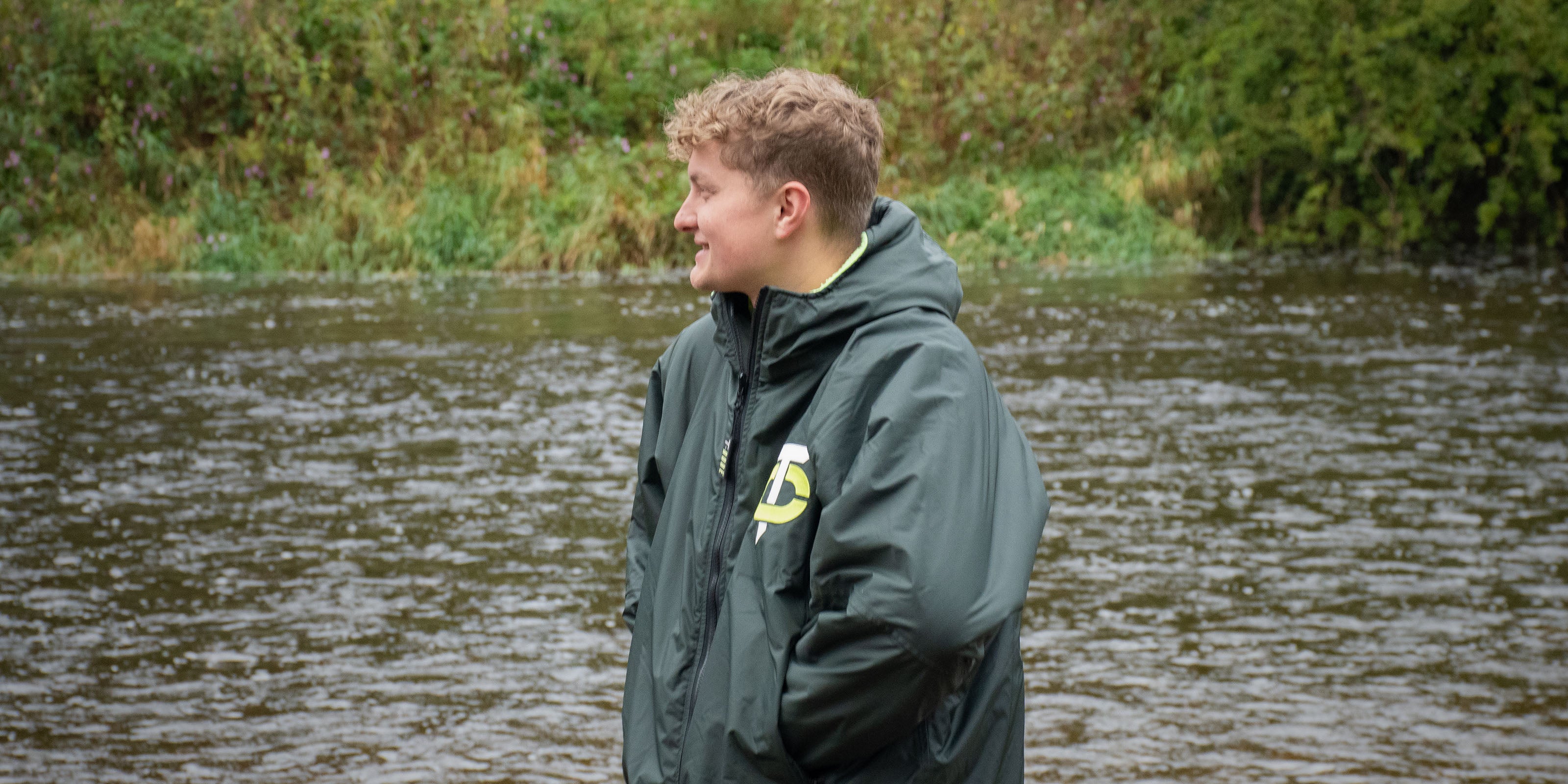 Image of man smiling wearing a T-Robe in front of a river