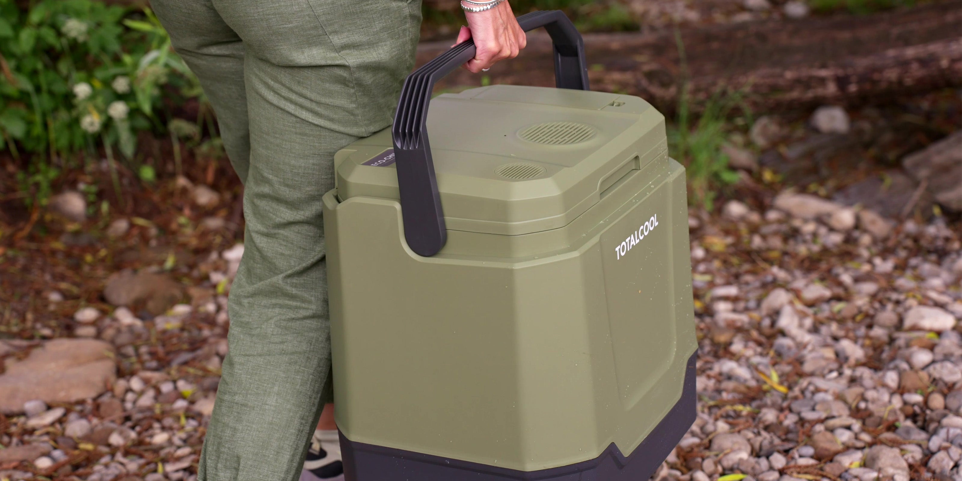 Image of the green Eco-chill 33 coolbox being carried along an outdoor path