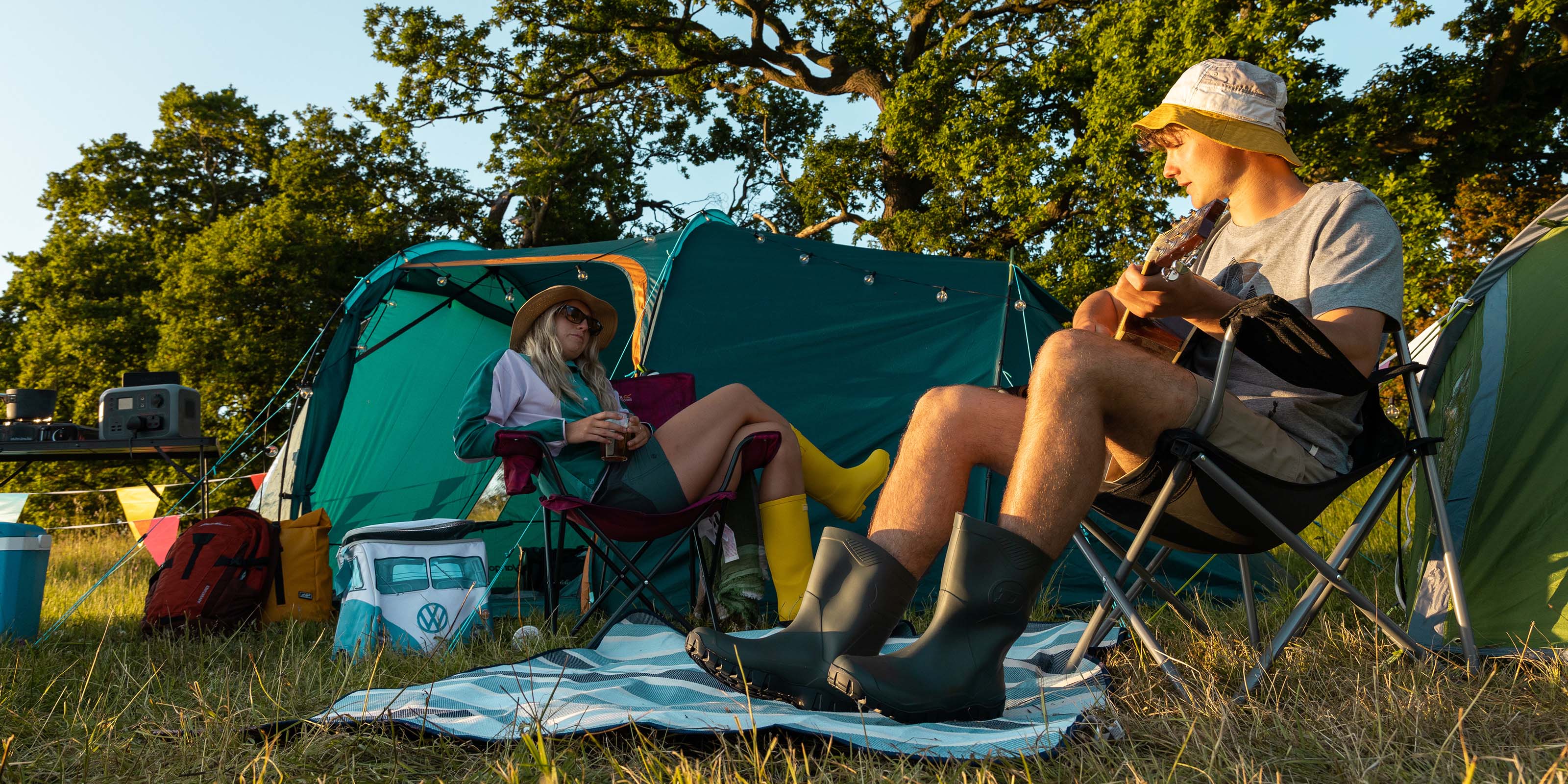 Image of a man and woman with tents set up at a festival using a TP500 as their powersource