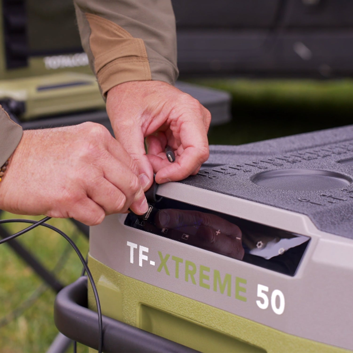 Image of someone lifting the rubber USB cover on the TF-XTREME 50 fridge freezer